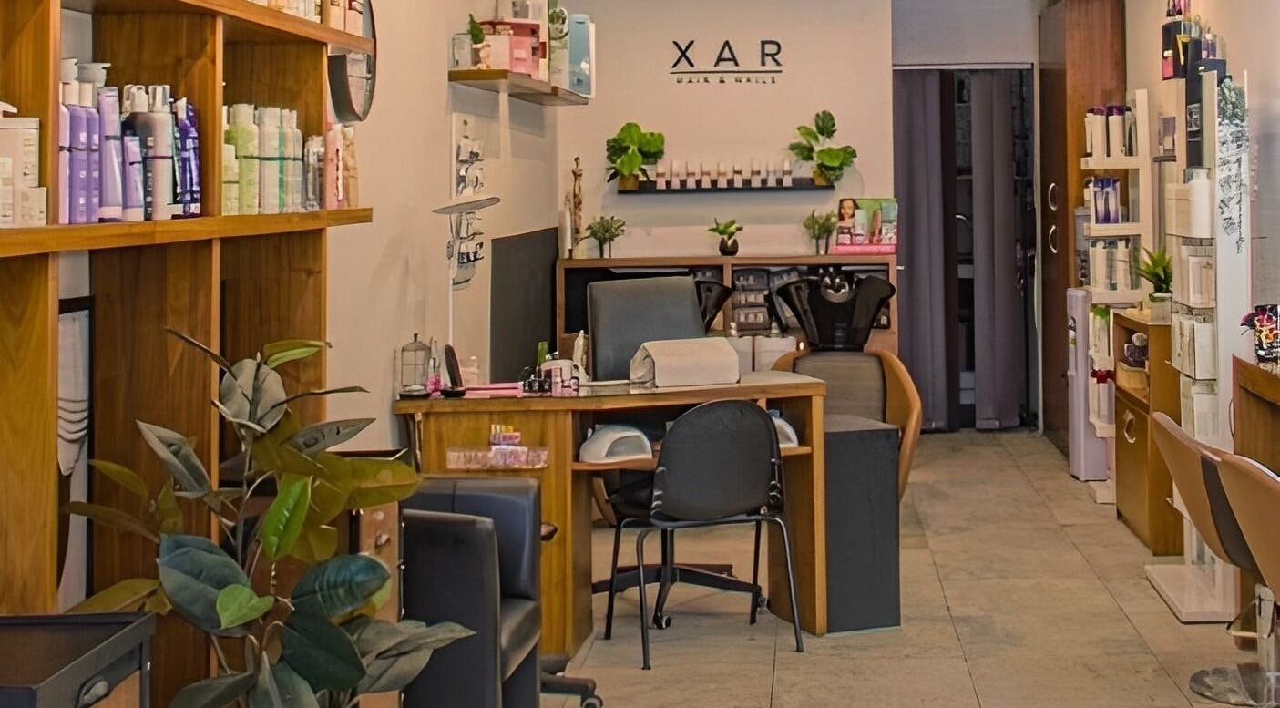 Relaxing interior of Xar Hair & Nails in Is-Swieqi, MT with stylish decor and beauty products on display.