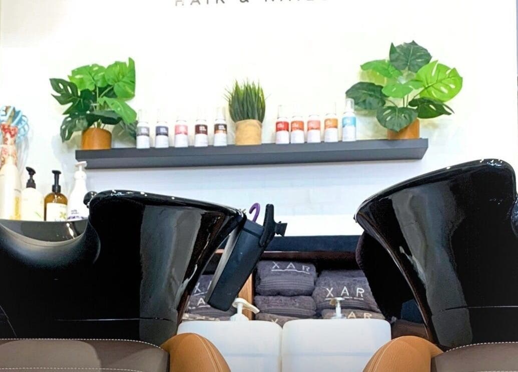 Stylish wash station at Xar Hair & Nails in Is-Swieqi, MT, showcasing modern salon design and lush decor.