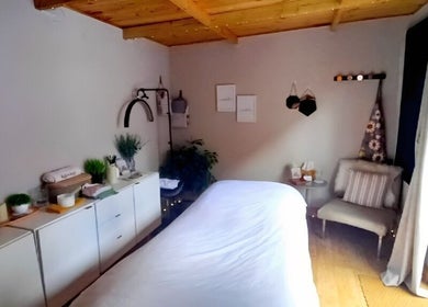Relaxing massage room at On Cloud Nine Therapies, Godalming, England, GB with a cozy bed and tranquil decor.