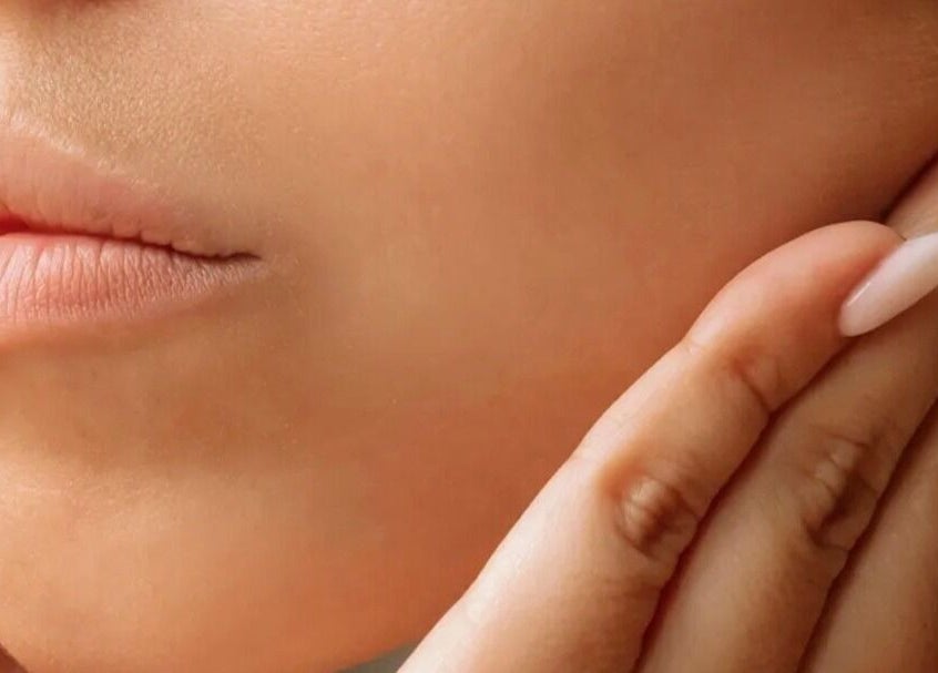 Close-up of gentle hands near face at On Cloud Nine Therapies, Godalming, England, GB, showcasing skin care.