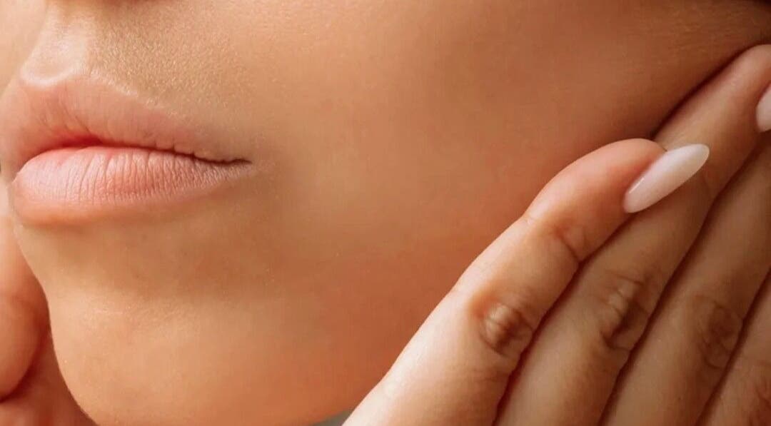 Close-up of gentle hands near face at On Cloud Nine Therapies, Godalming, England, GB, showcasing skin care.