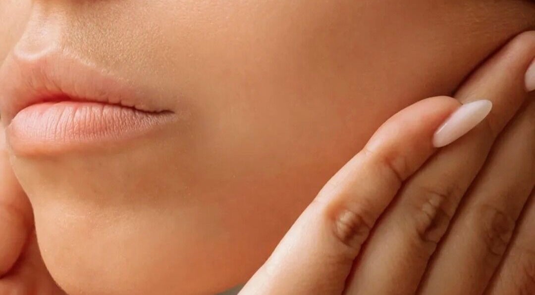 Close-up of gentle hands near face at On Cloud Nine Therapies, Godalming, England, GB, showcasing skin care.