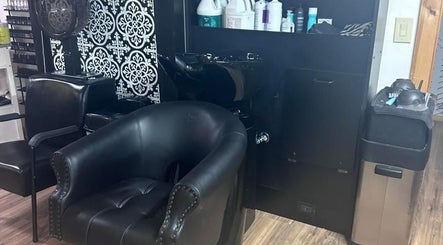 Relaxing salon corner with black chairs and hair washing station at The Scissor Shoppe, Worthington, Pennsylvania, US.