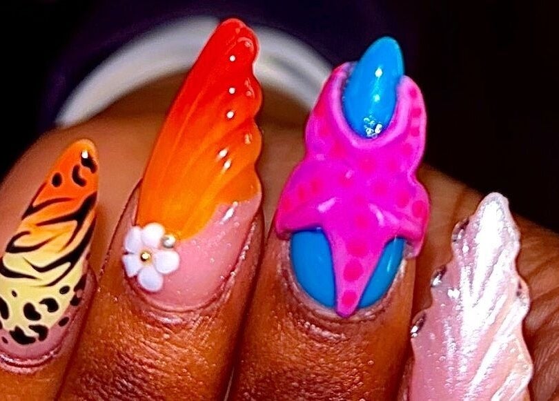 Colorful nail designs at Claws With Jas in Memphis, Tennessee, US showcasing intricate patterns and vibrant colors.