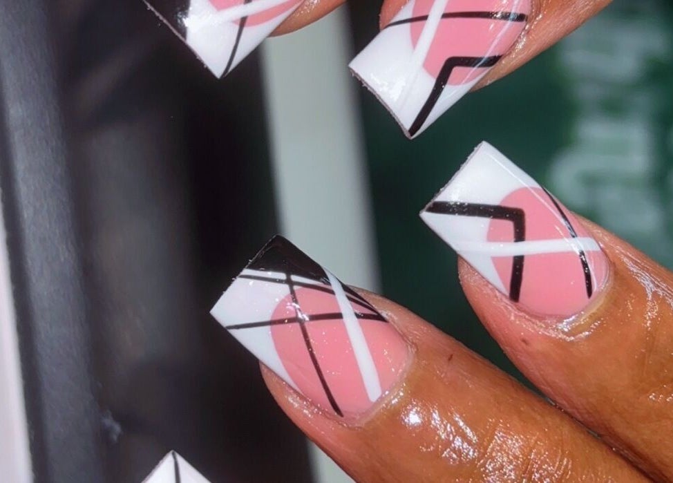 Close-up of geometric nail art in pink, black, and white at Claws With Jas, Memphis, Tennessee, US.