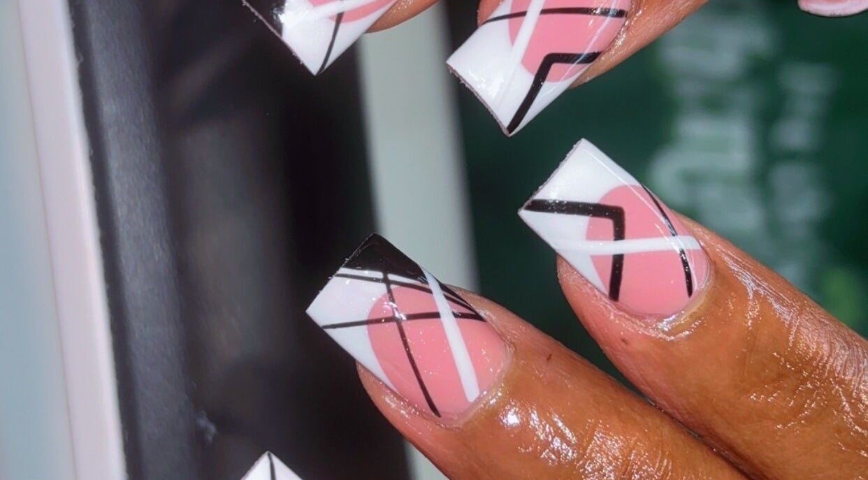 Close-up of geometric nail art in pink, black, and white at Claws With Jas, Memphis, Tennessee, US.