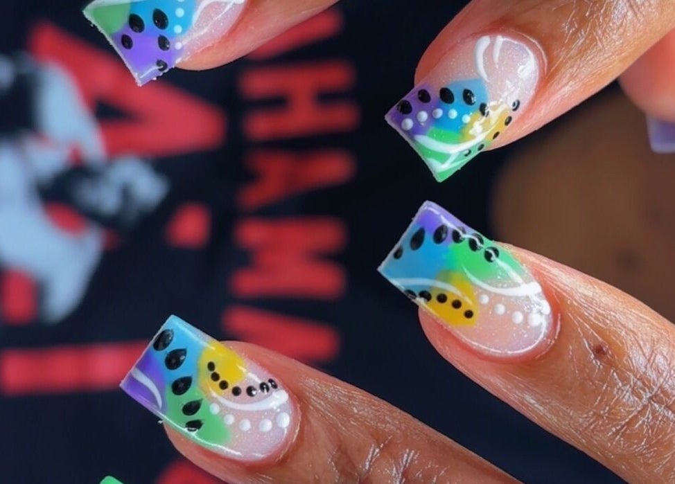 Vibrant rainbow nail art at Claws With Jas in Memphis, Tennessee, US, showcasing detailed designs and colors.
