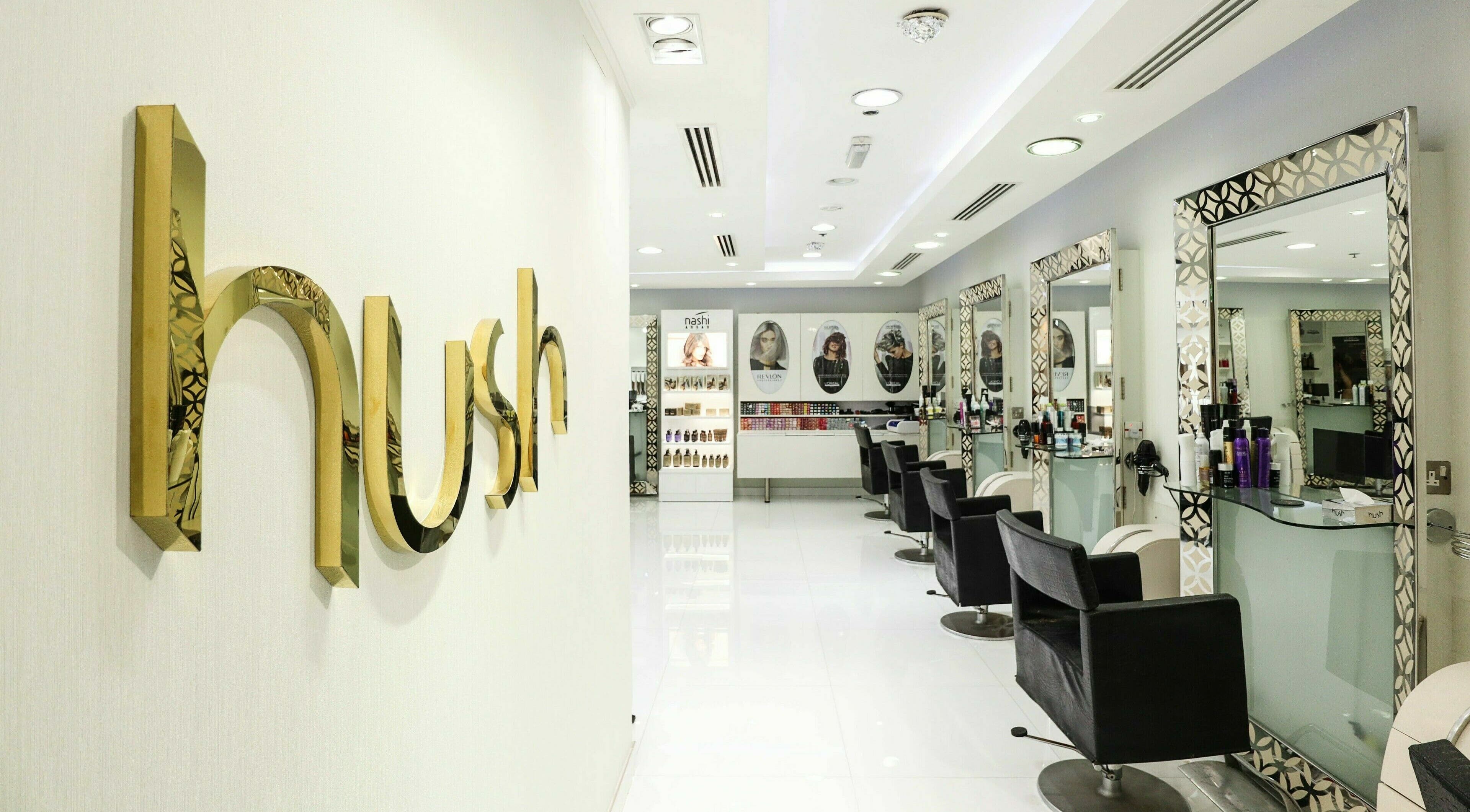 Chic interior of Hush Salon Wafi Mall, Dubai, AE with luxurious salon chairs and mirrors.