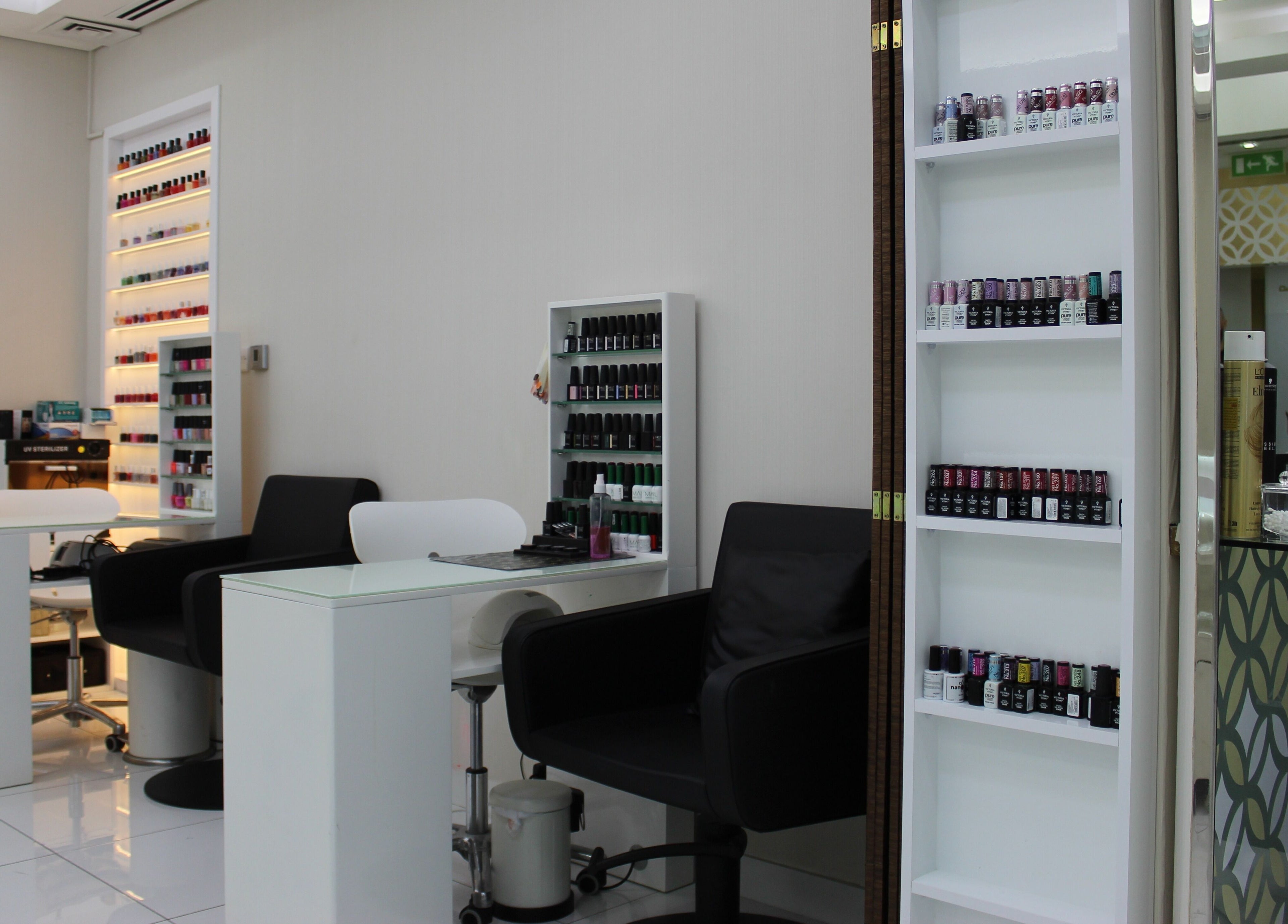 Modern nail studio at Hush Salon Kempinski Central Avenue of Dubai, showcasing polish selection. Dubai, Dubai, AE.