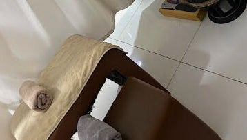 Massage table at Foot Rest Salon & Aesthetics in Malé, Male, MV, ready with folded towels for a soothing session.
