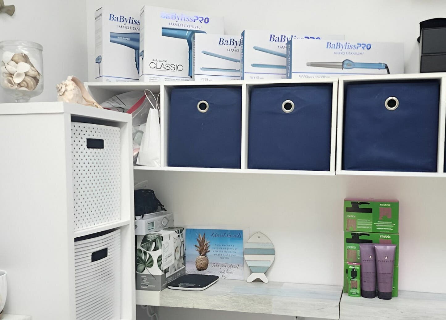 Organized shelf with beauty products at Gemproimage, Miami, Florida. Blue bins and hair tools displayed.