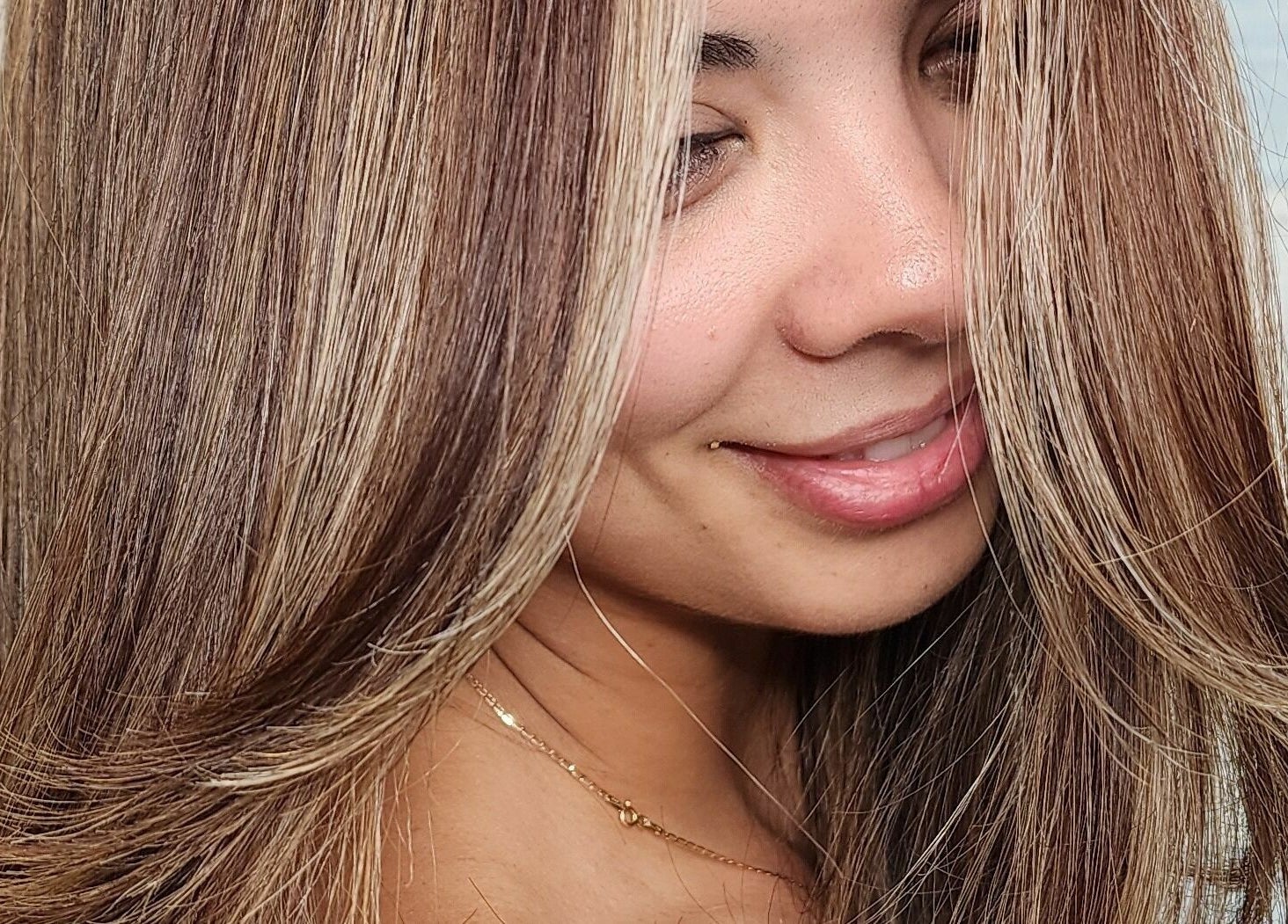 Smiling woman with radiant hair highlights at Gemproimage, Miami, Florida, US.