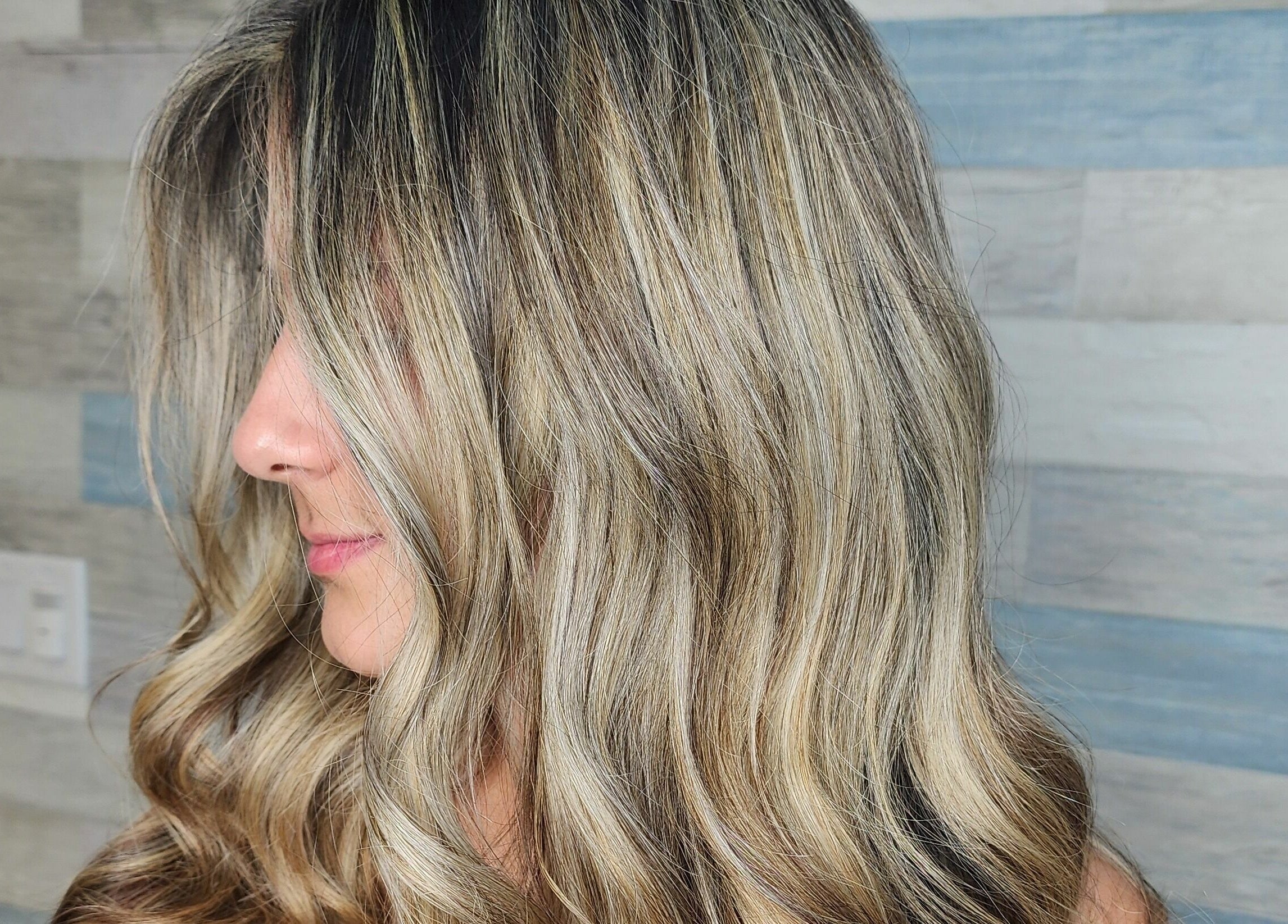 Close-up of smooth, wavy blonde hair at Gemproimage, Miami, Florida, US. Elegant salon style.