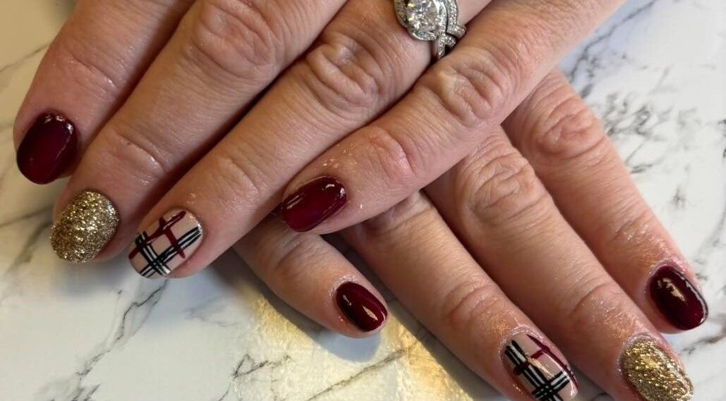 Stylish nail art at The Little Beauty Rooms, Glengormley, Northern Ireland, GB. Burgundy tones and gold glitter.