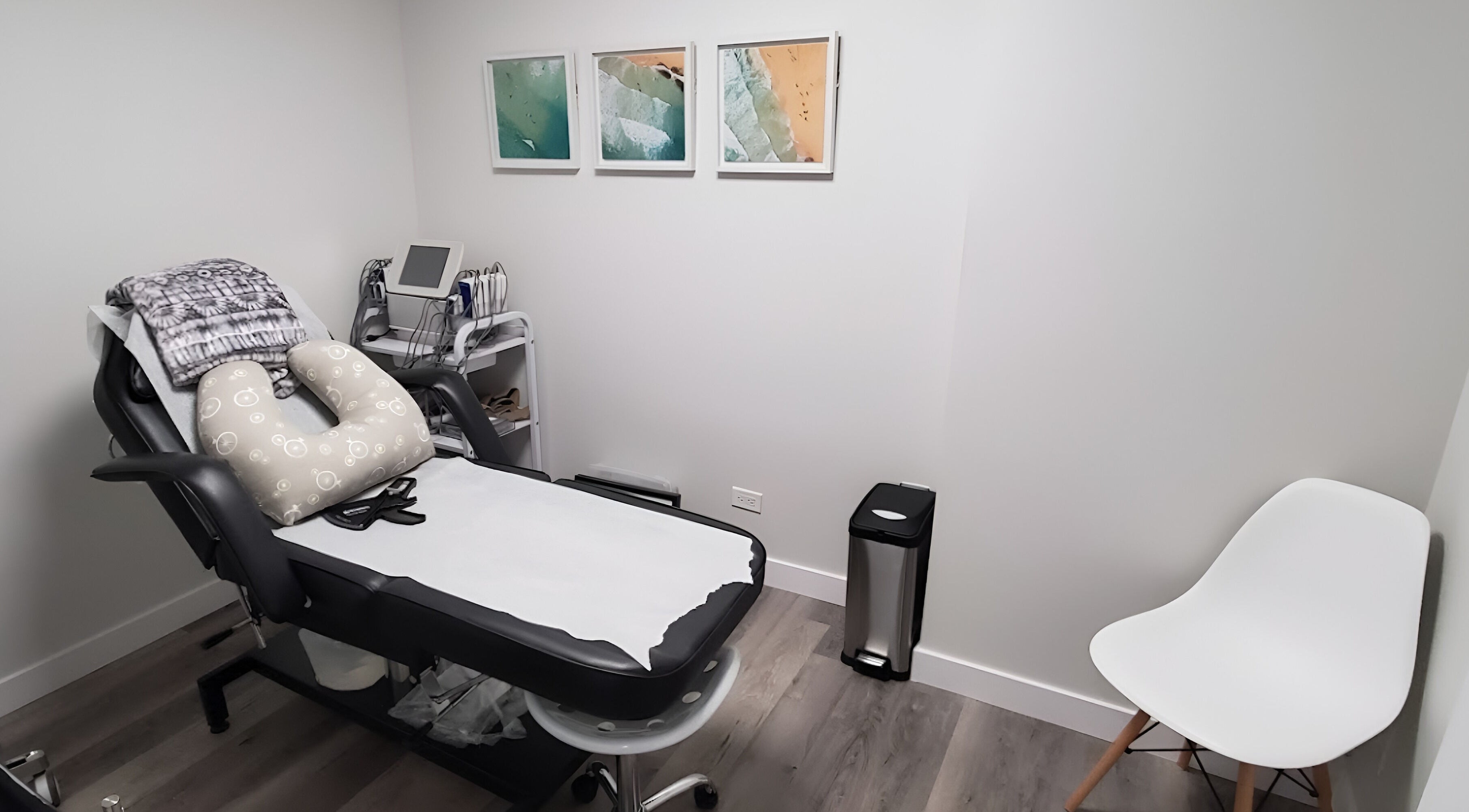 Cozy treatment room at BodiMedic Contouring and Wellness, Edmonton, Alberta, CA with modern decor and comfy chair.