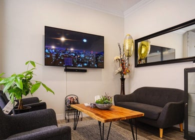 Inviting lounge area at BodiMedic Contouring and Wellness, Edmonton, Alberta, CA with modern decor and plants.