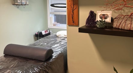 Cozy treatment room at Honey Lashes by V, Nanaimo, British Columbia, CA, featuring a massage bed and decor.