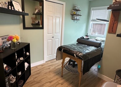 Cozy treatment room at Honey Lashes by V in Nanaimo, British Columbia, CA with elegant decor and therapy bed.