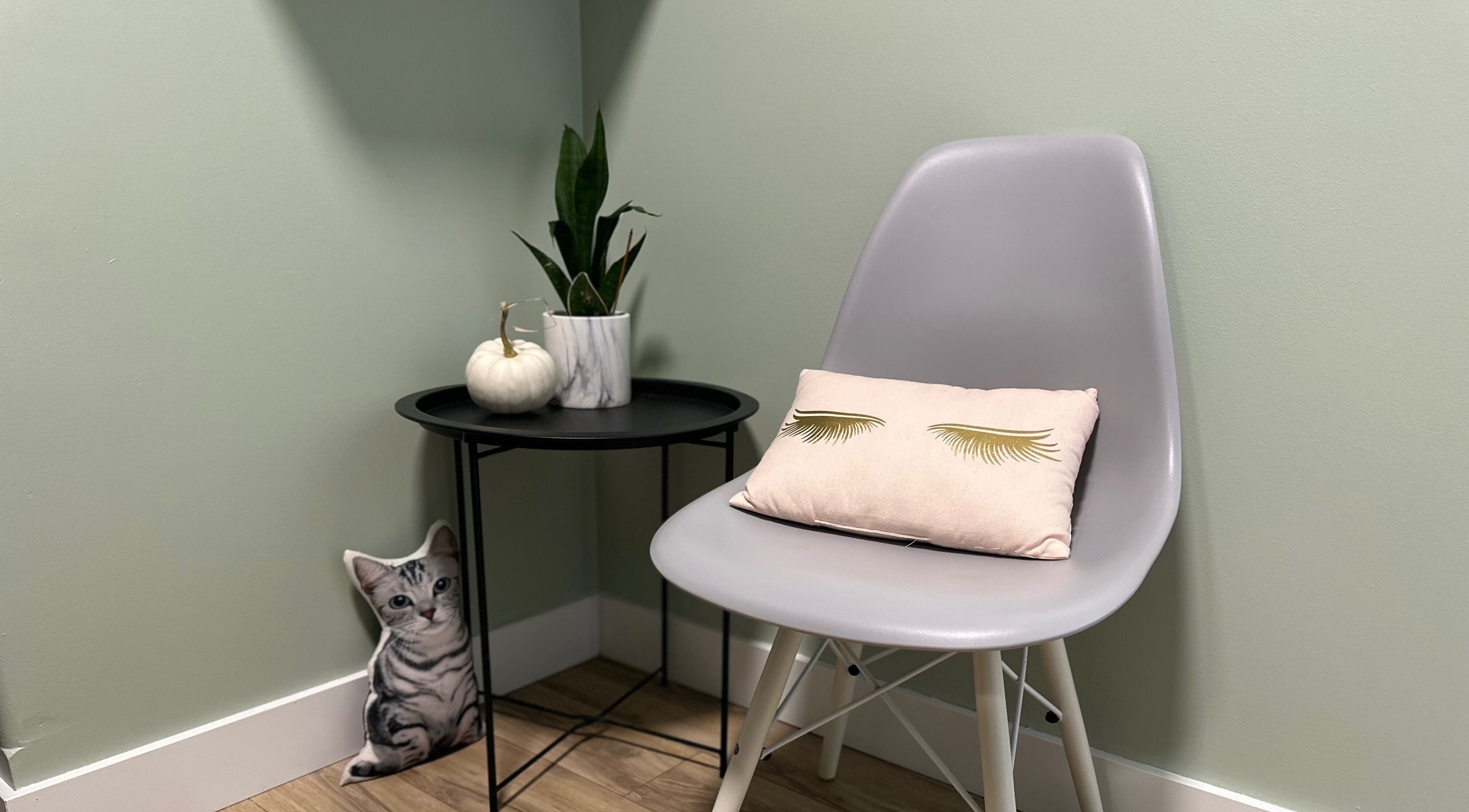 Modern chair and table setup at Honey Lashes by V, Nanaimo, British Columbia, CA with decorative plants.