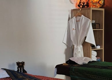 Tranquil massage room at Sasinan Thai Spa, Sherwood, Queensland, AU featuring massage beds and robes.