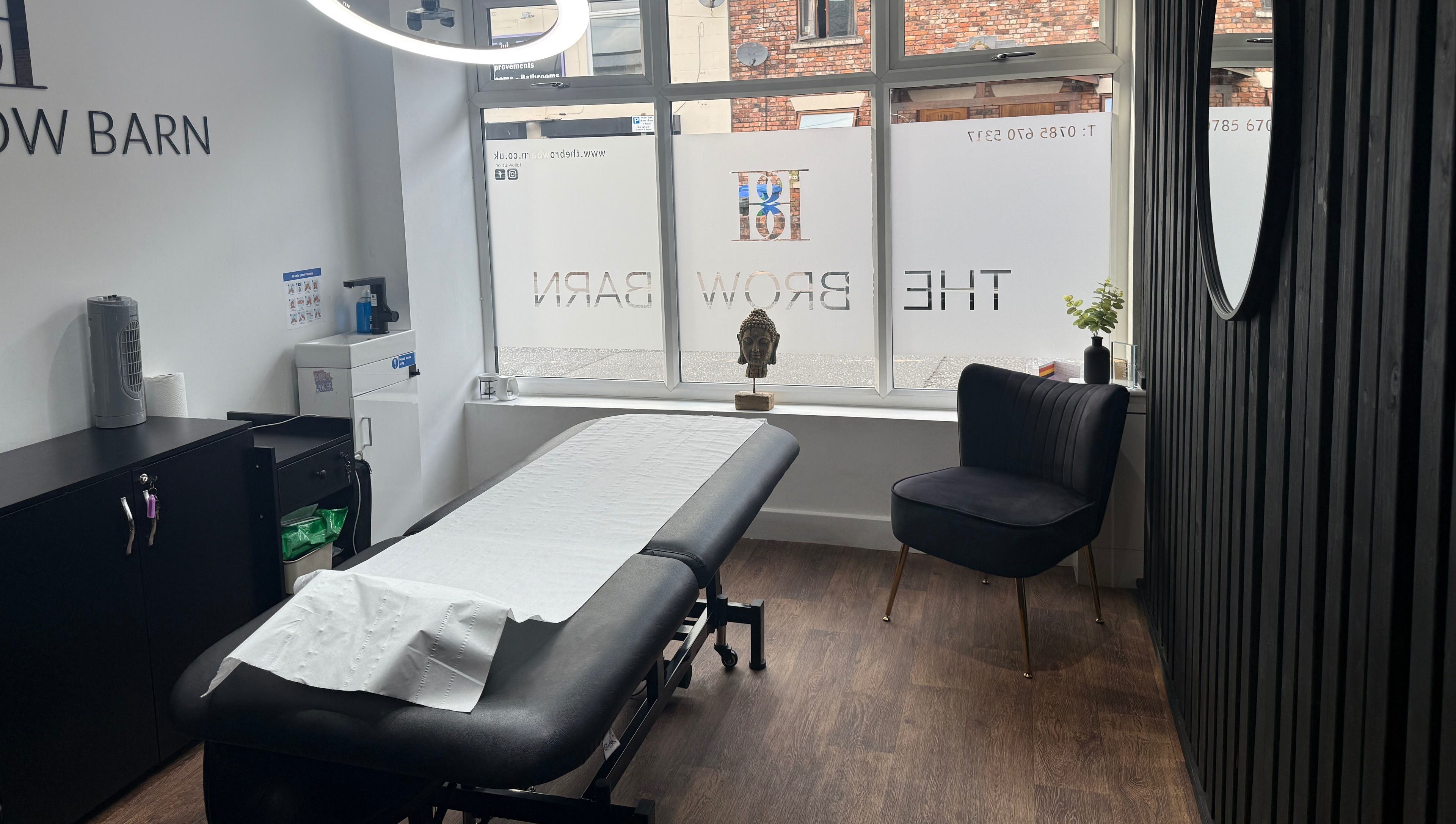 Modern treatment room at The Brow Barn, Middleton, England, GB, featuring a spa bed and contemporary decor.