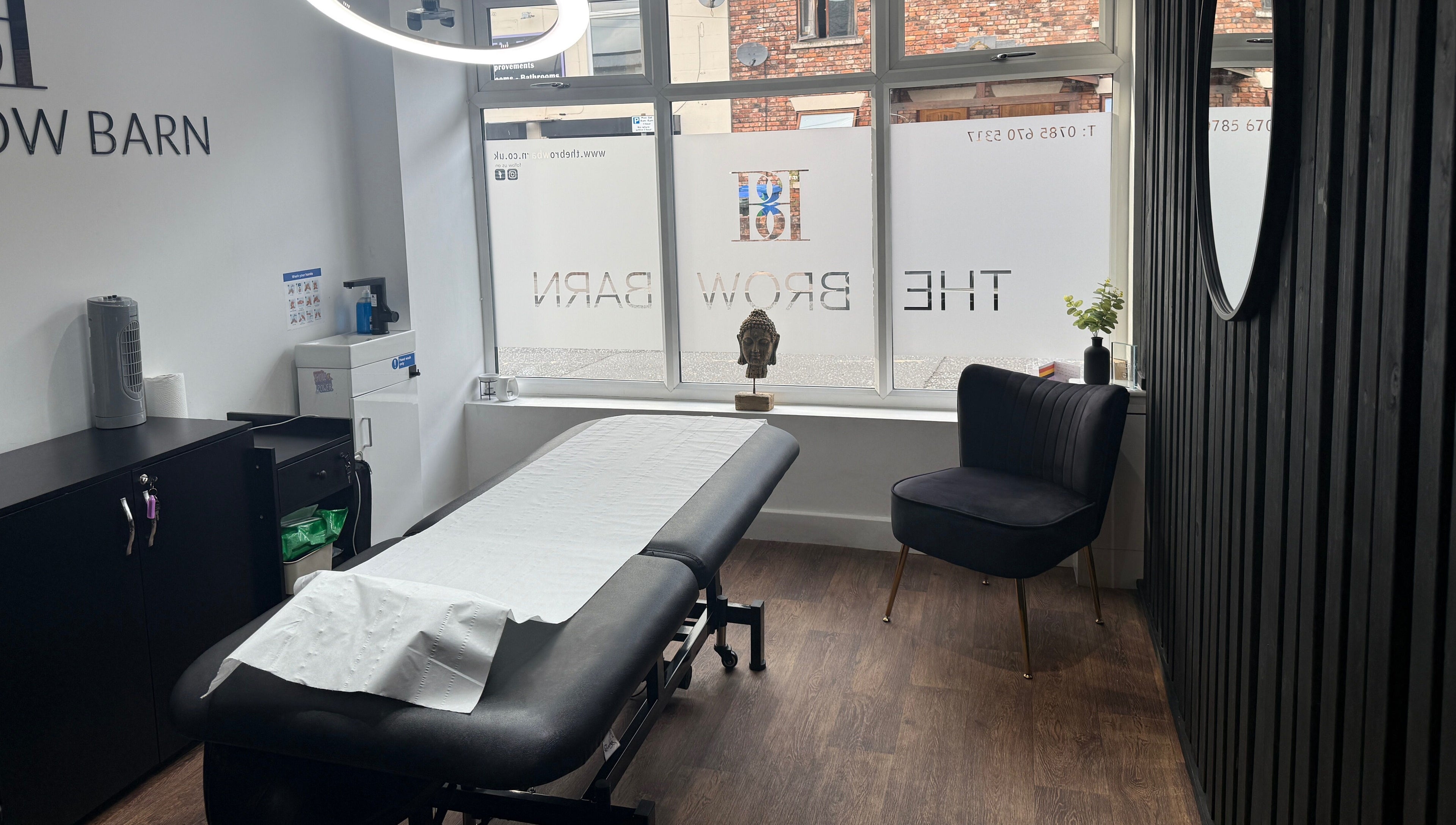 Modern treatment room at The Brow Barn, Middleton, England, GB, featuring a spa bed and contemporary decor.