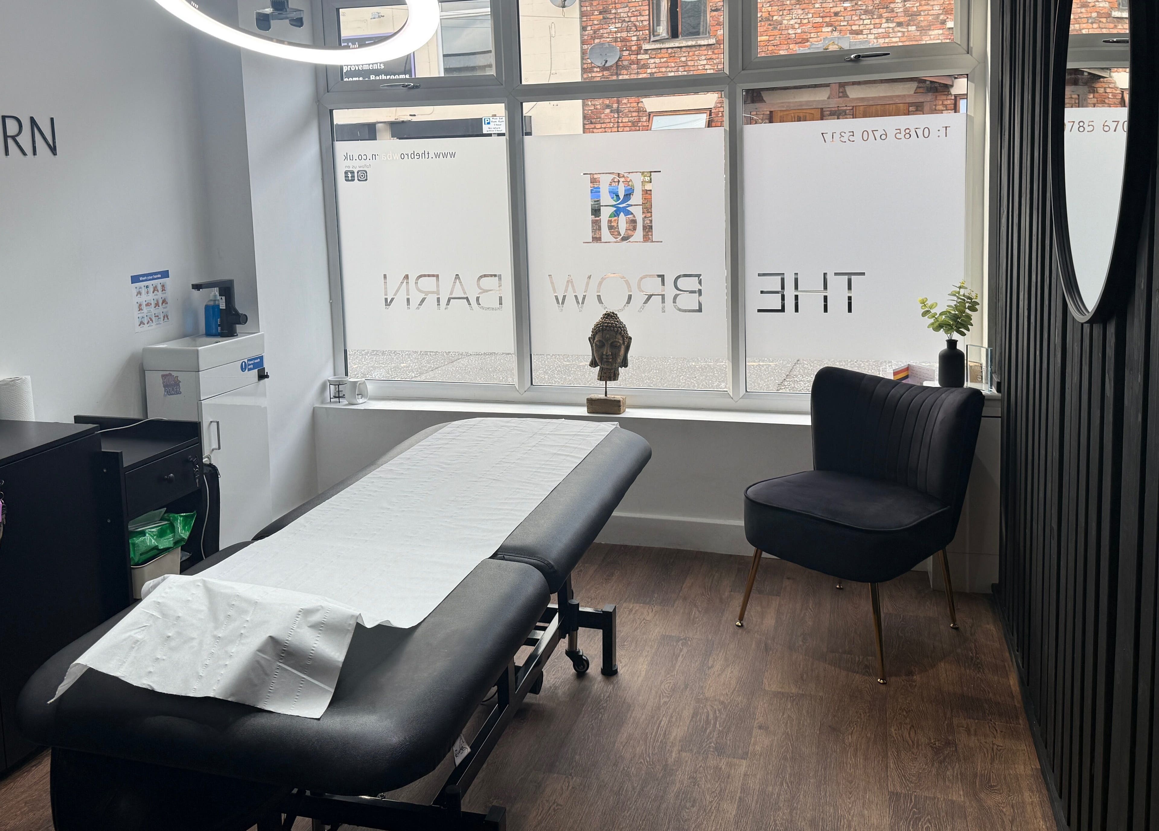 Modern treatment room at The Brow Barn, Middleton, England, GB, featuring a spa bed and contemporary decor.