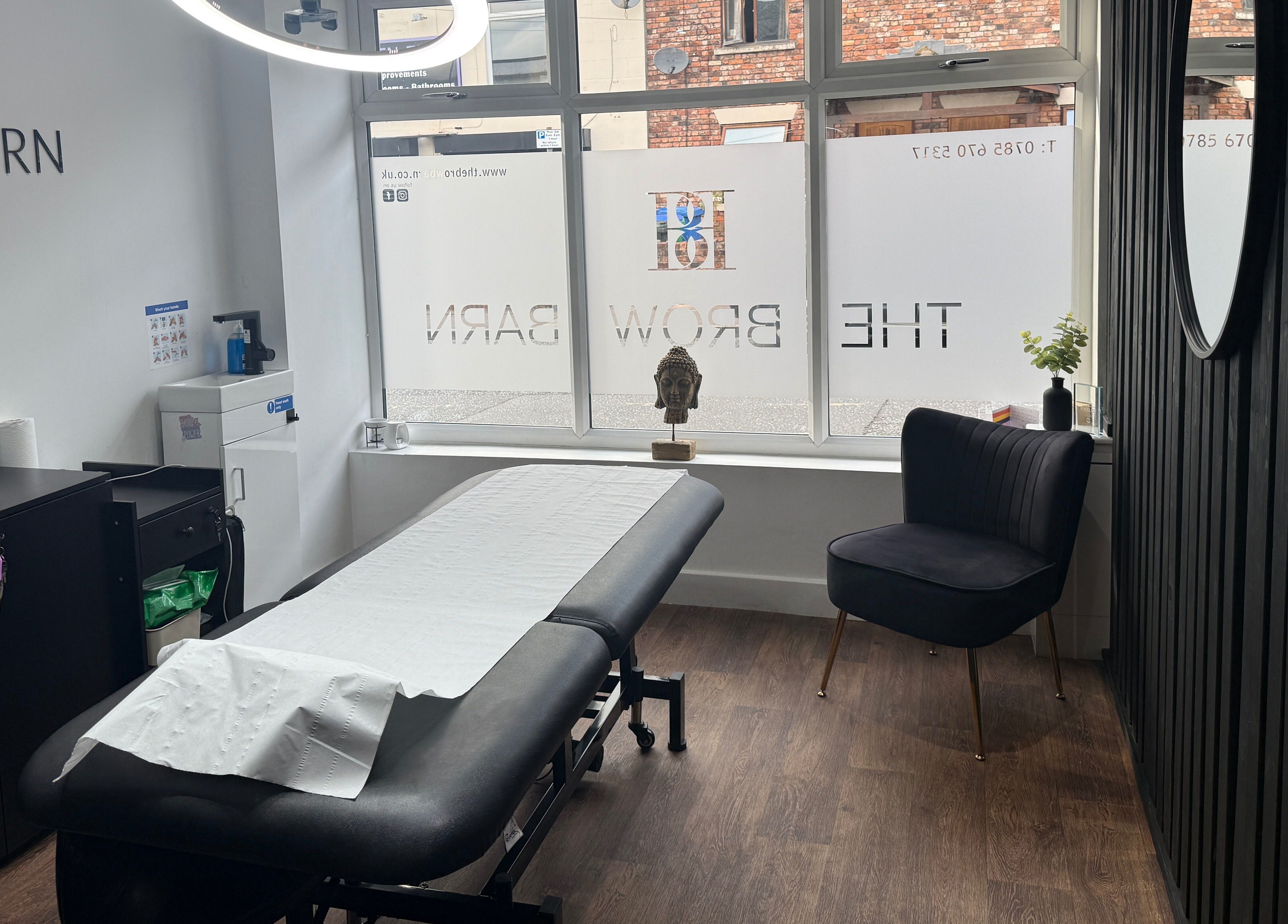 Modern treatment room at The Brow Barn, Middleton, England, GB, featuring a spa bed and contemporary decor.