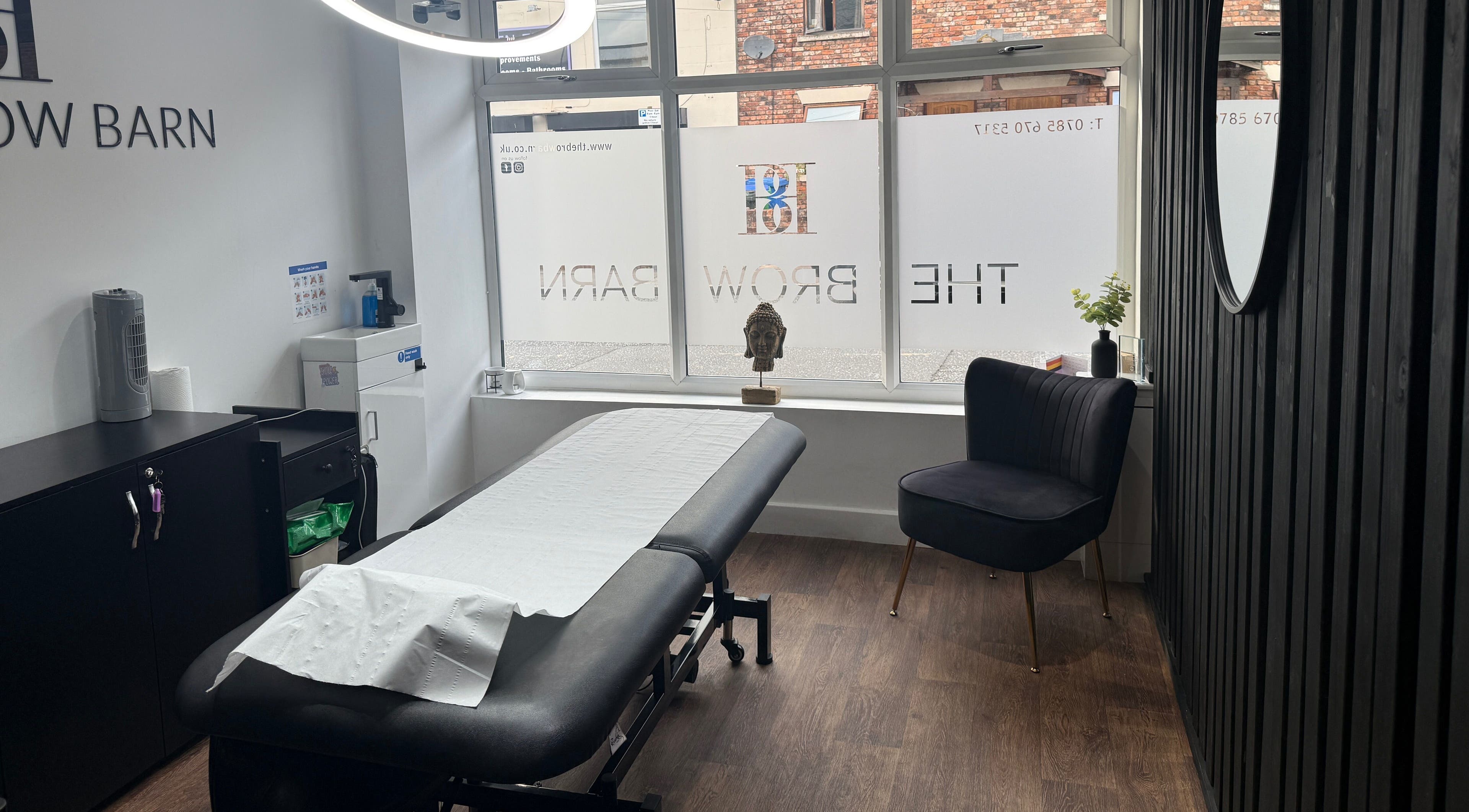 Modern treatment room at The Brow Barn, Middleton, England, GB, featuring a spa bed and contemporary decor.
