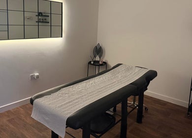 Relaxing treatment room at The Brow Barn, Middleton, England, GB, featuring a modern massage table and decor.