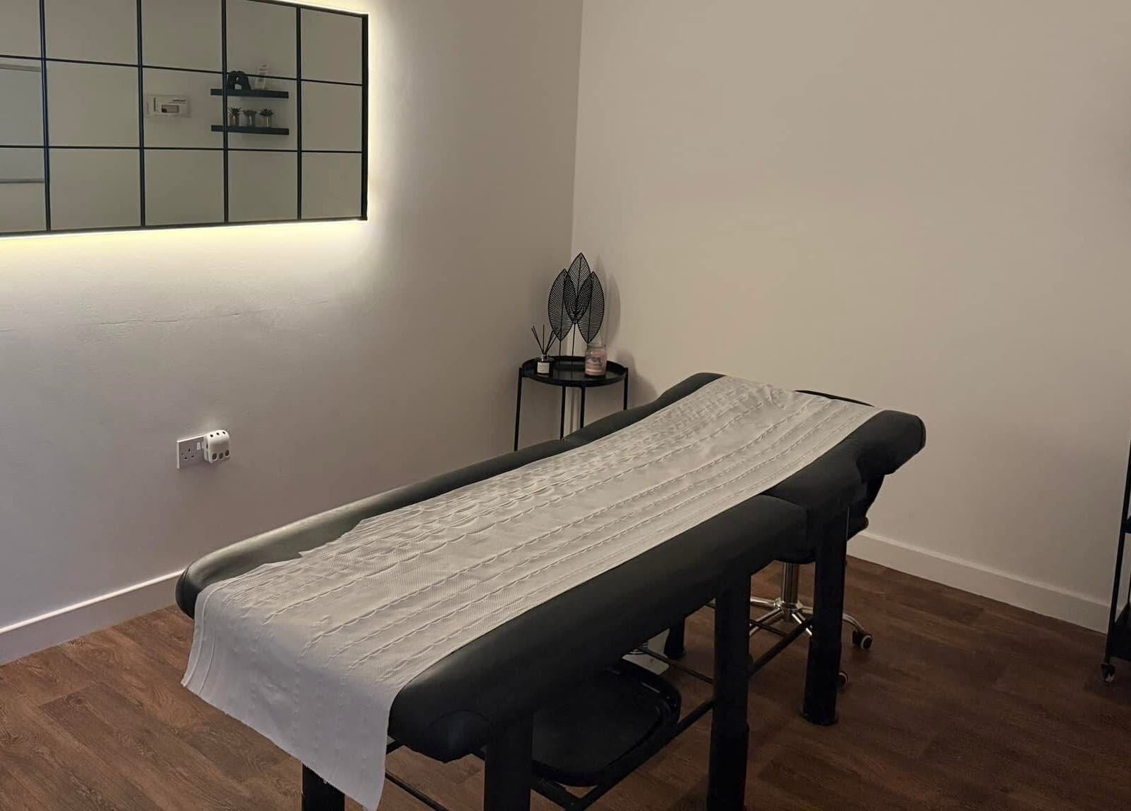 Relaxing treatment room at The Brow Barn, Middleton, England, GB, featuring a modern massage table and decor.