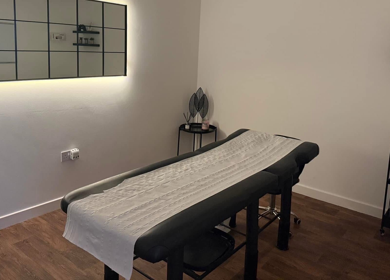 Relaxing treatment room at The Brow Barn, Middleton, England, GB, featuring a modern massage table and decor.