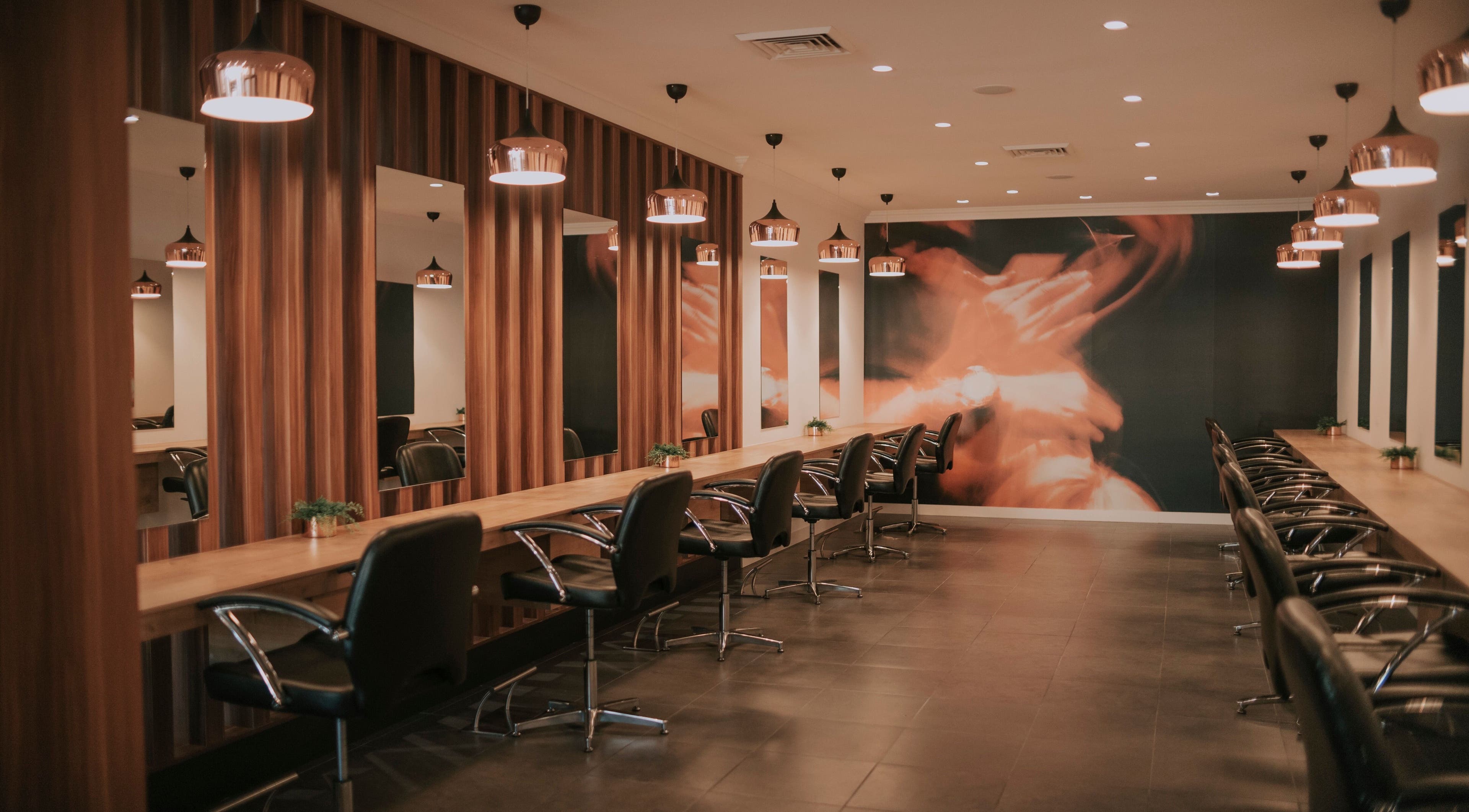 Chic interior of David Lee Hair in Perth, Western Australia, AU with stylish salon chairs and modern lighting.