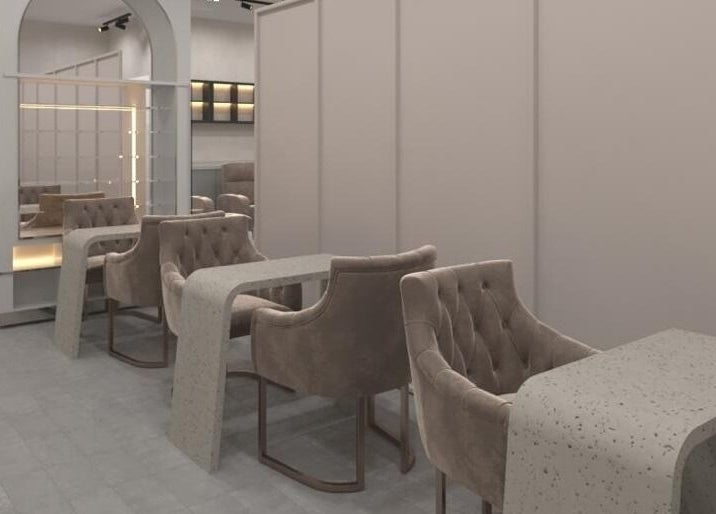 Elegant nail area at Gladys Motor City Branch, Dubai, AE showcasing sleek chairs and tables.