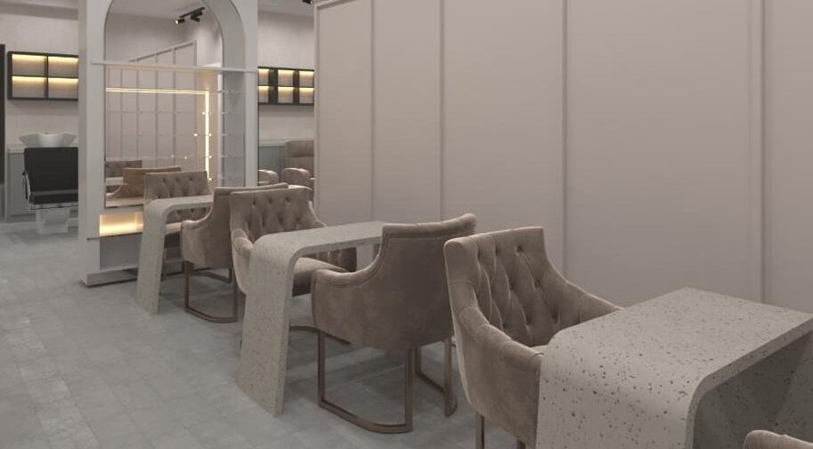Elegant nail area at Gladys Motor City Branch, Dubai, AE showcasing sleek chairs and tables.