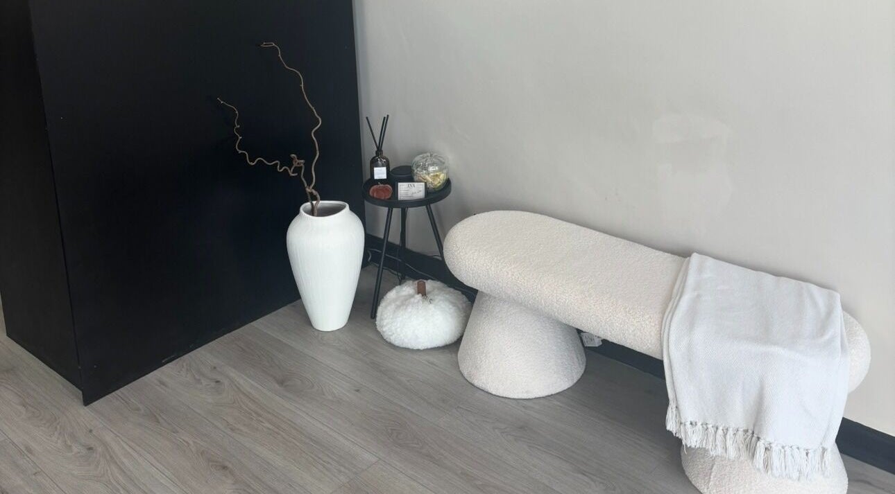 Elegant seating area at INX Cosmetics in Great Wyrley, England, GB with minimalist decor.