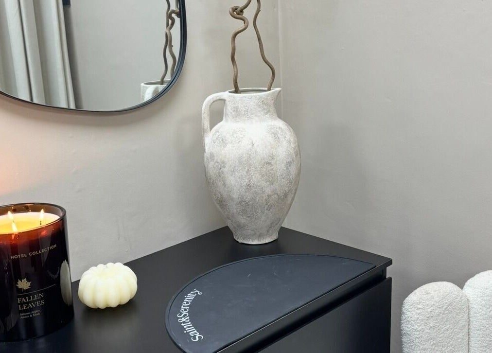 Elegant vase and candle at INX Cosmetics, Great Wyrley, England, GB, creating a relaxing ambiance.