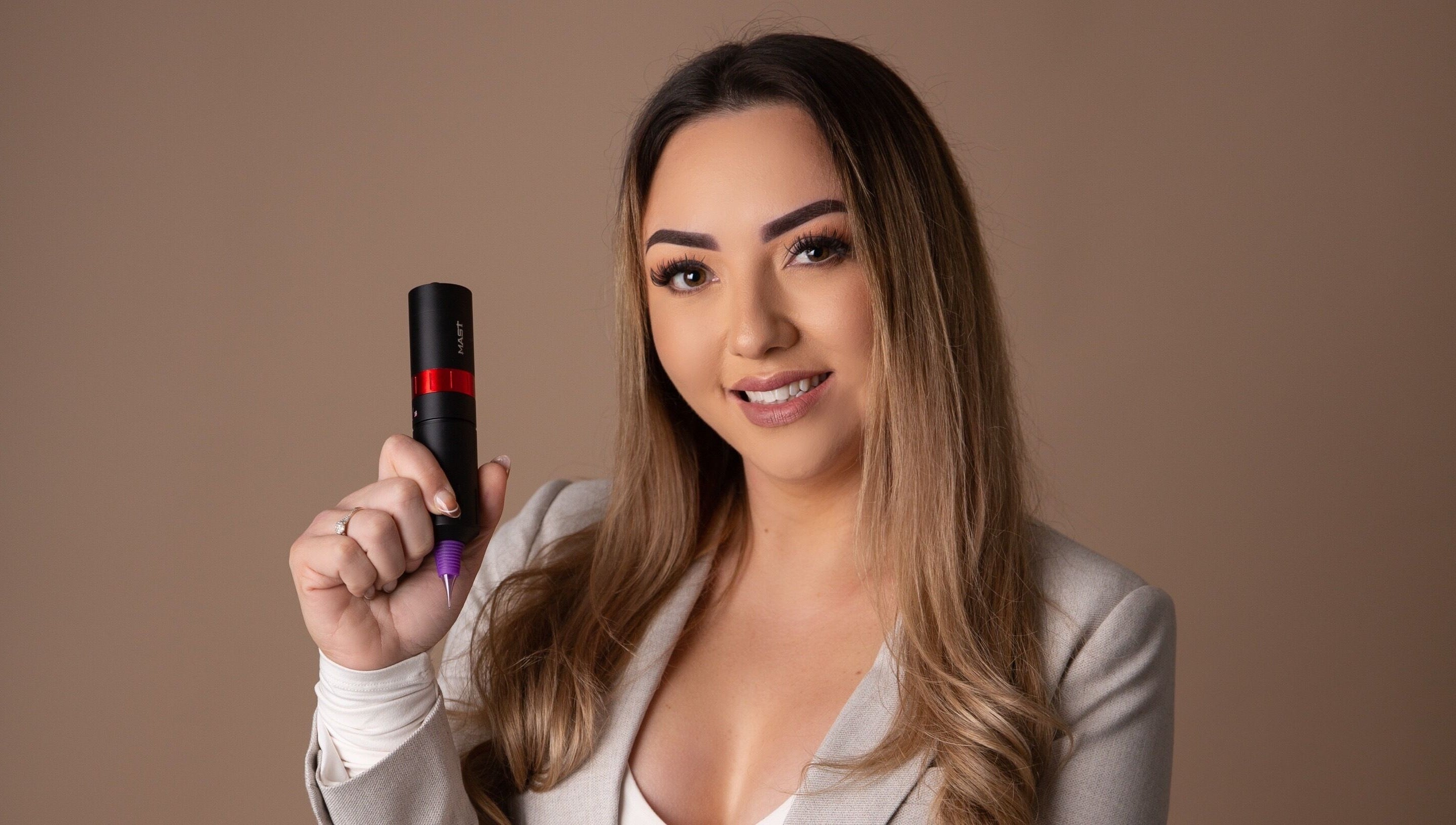 Professional artist at Blink & Ink Tawa holding a tattoo tool in Wellington, Wellington Region, NZ.