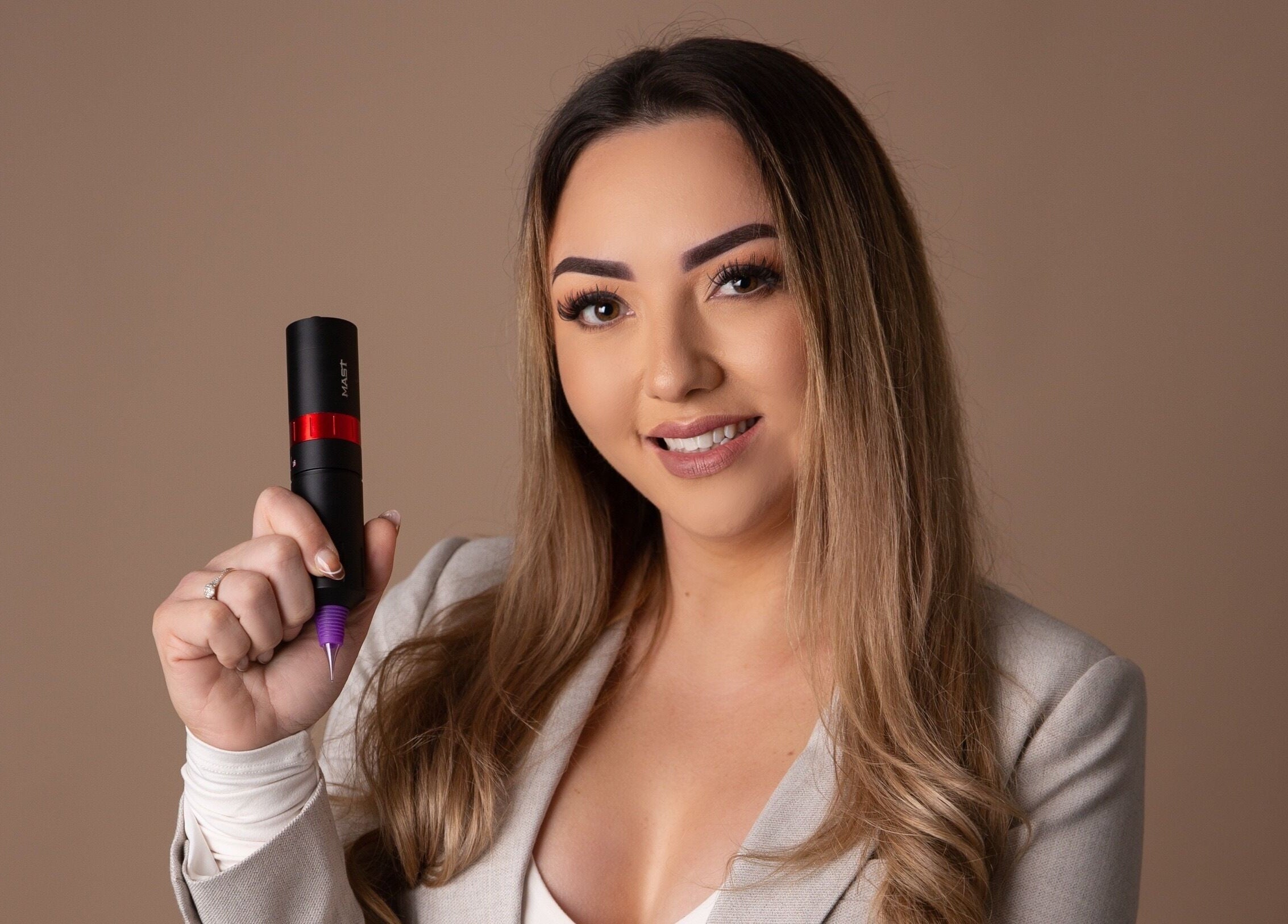 Professional artist at Blink & Ink Tawa holding a tattoo tool in Wellington, Wellington Region, NZ.