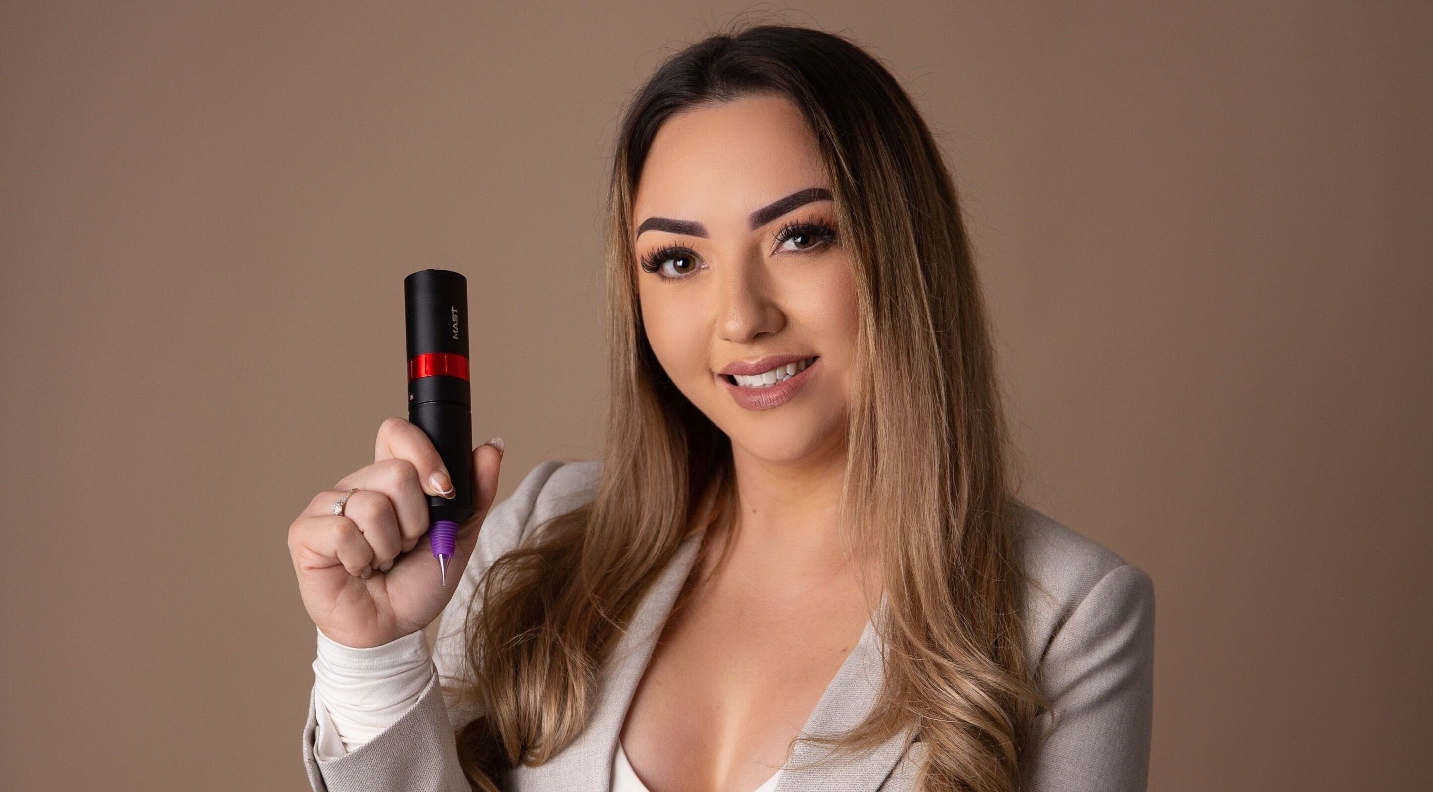 Professional artist at Blink & Ink Tawa holding a tattoo tool in Wellington, Wellington Region, NZ.