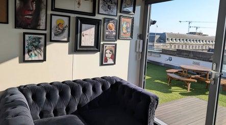 Cozy corner at Organic Joy Tattoo with framed art and terrace view in Dublin, County Dublin, IE.
