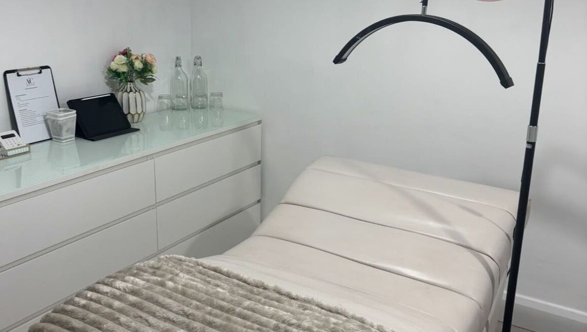 Cozy, modern beauty treatment room at The AC Studio, Naas, County Kildare, IE featuring a plush bed and sleek decor.