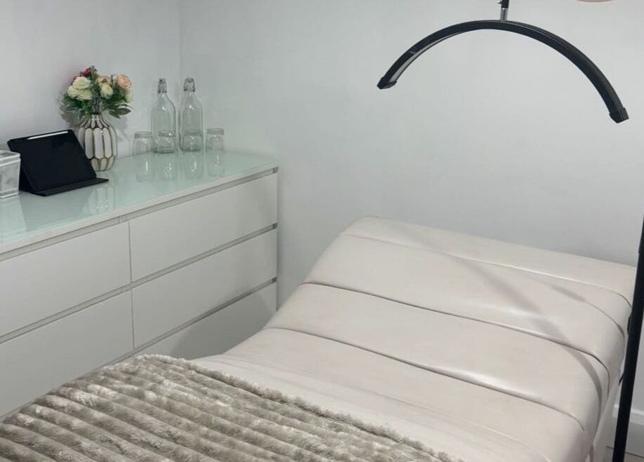 Cozy, modern beauty treatment room at The AC Studio, Naas, County Kildare, IE featuring a plush bed and sleek decor.