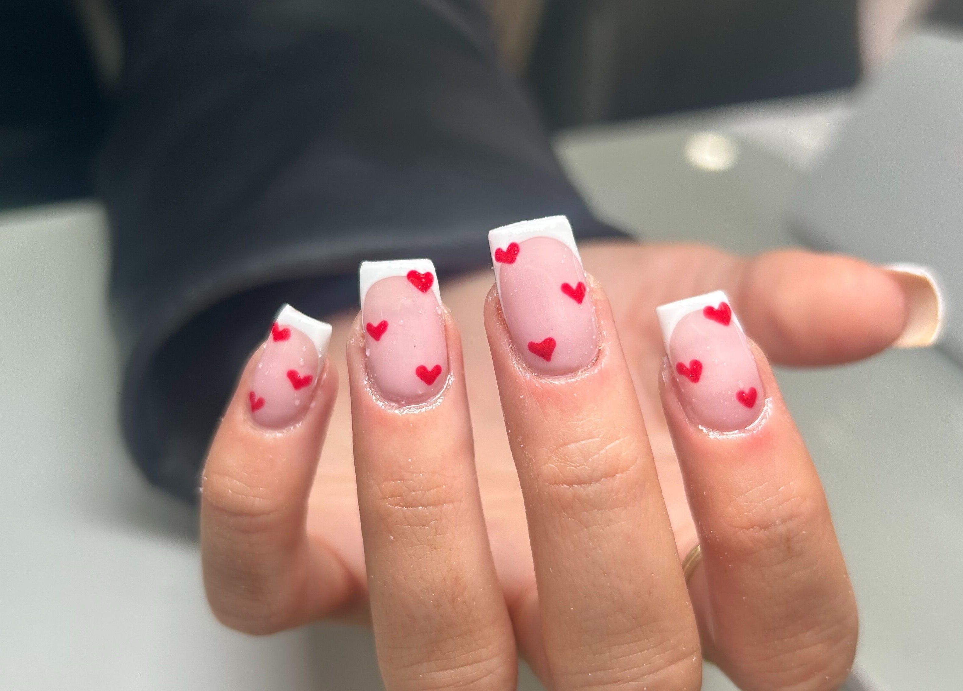 Elegant nail art with red hearts at Nails By Mya, Blantyre, Scotland, GB.