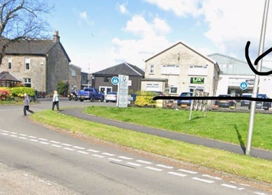 Street view of Rhi lly Braw Nails & Beauty, Linwood, Scotland, GB with parked cars and pedestrians.