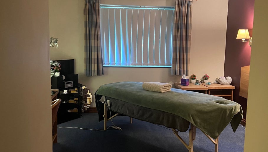 Relaxing therapy room at Pure Massage Therapy, Newton Abbot, England, GB with a cozy massage table.