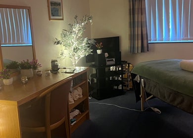 Cozy therapy room at Pure Massage Therapy, Newton Abbot, England, GB with massage table and ambient lighting.
