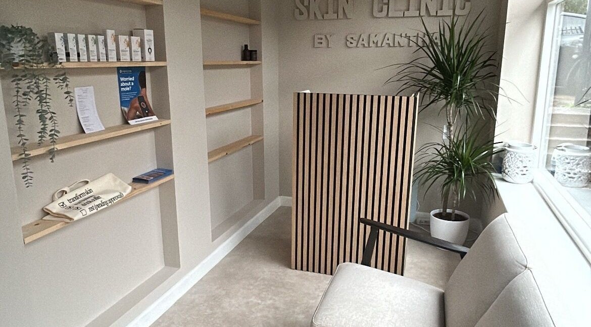 Reception area at Skin Clinic By Samantha in Lydney, England, GB featuring minimalist decor and cozy seating.
