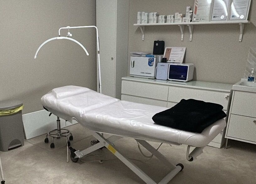 Treatment room at Skin Clinic By Samantha, Lydney, England, GB, featuring a treatment bed and skincare products.