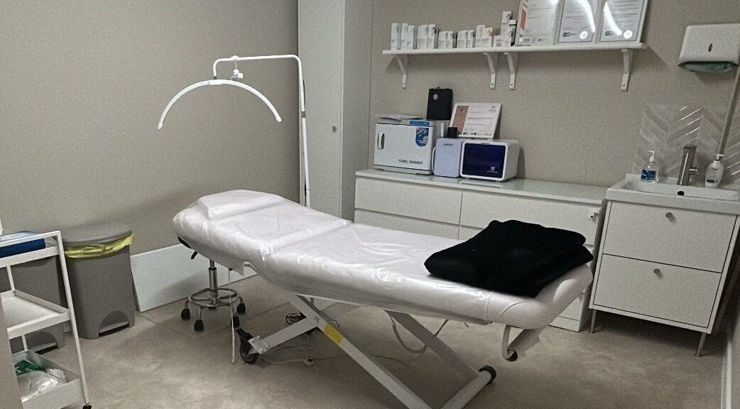 Treatment room at Skin Clinic By Samantha, Lydney, England, GB, featuring a treatment bed and skincare products.